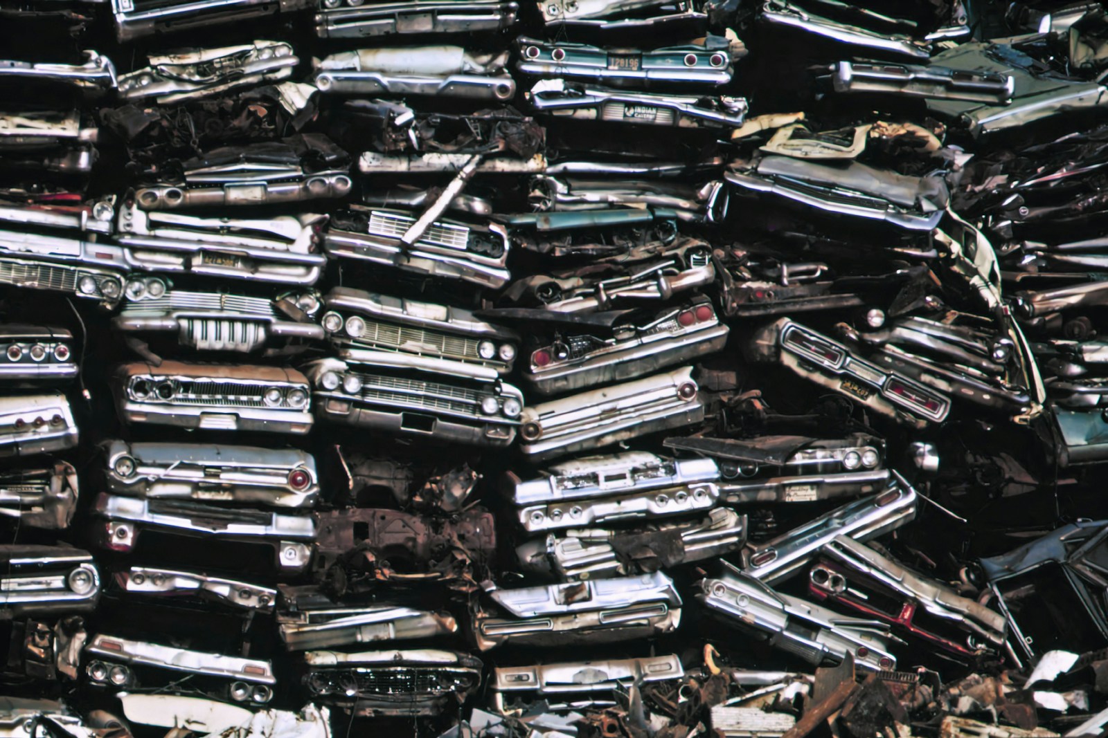 a pile of old cars sitting next to each other